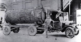Ford Model TT truck hauling a massive log in Missouri